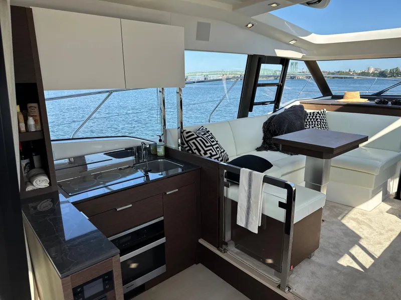 Slide: The Image of Interior of 2021 Prestige 420 S yacht with modern kitchen and seating area. - 16
