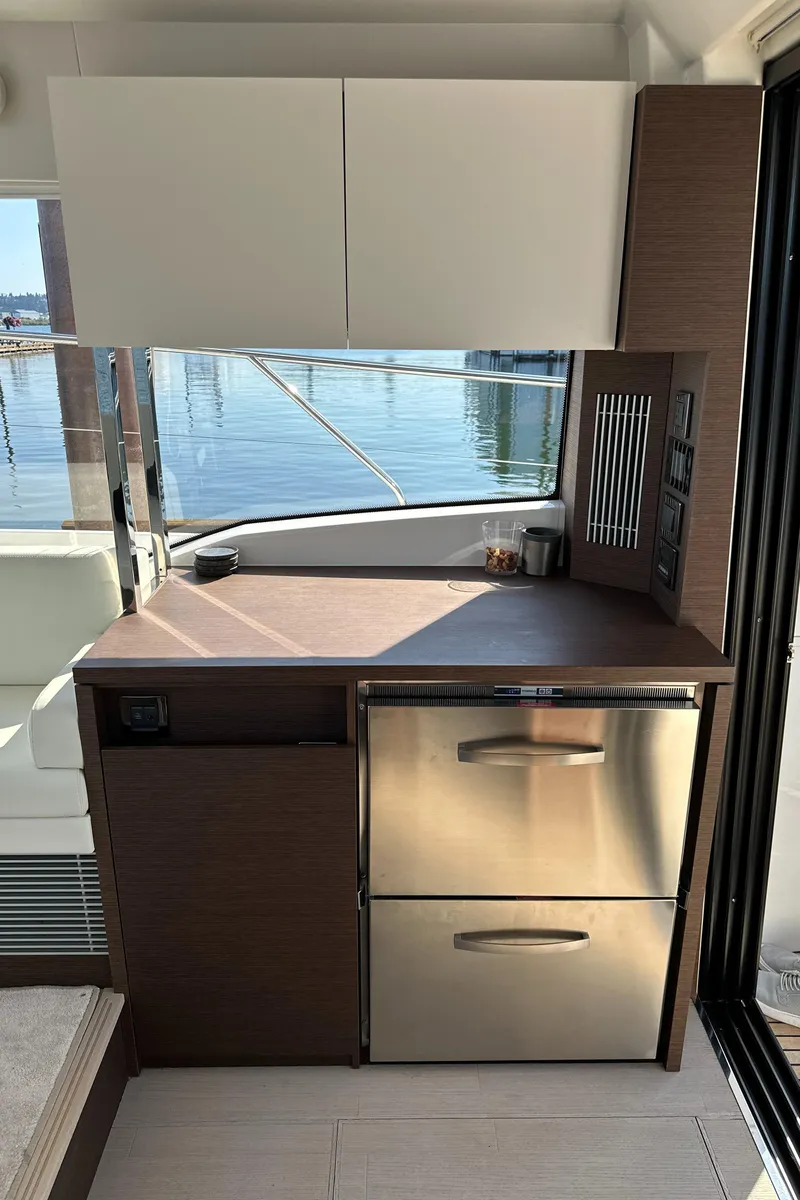 Slide: The Image of Modern kitchen area on a 2021 Prestige 420 S yacht with stainless steel appliances. - 18