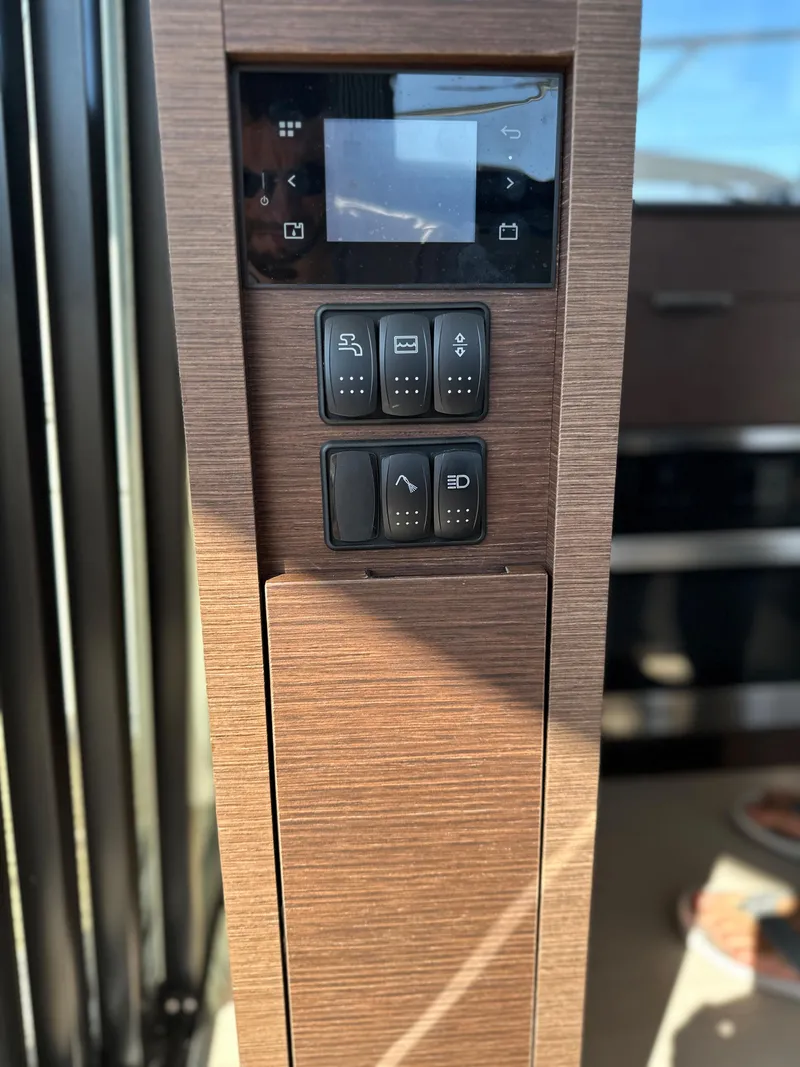 Slide: The Image of Control panel of a 2021 Prestige 420 S yacht with wooden finish. - 23