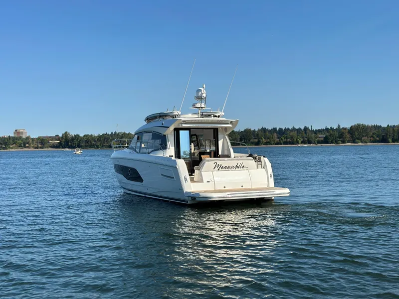 Slide: The Image of Prestige 420 S 2021 yacht cruising on a serene lake with clear blue skies. - 3