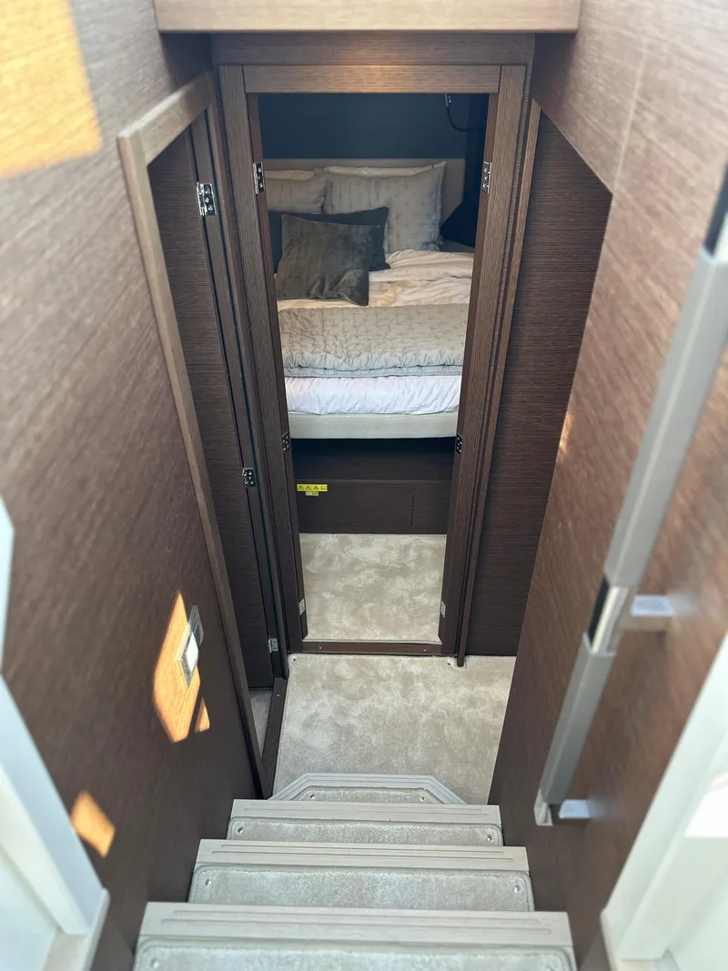 Slide: The Image of Interior view of 2021 Prestige 420 S yacht showing stairs leading to a cozy bedroom. - 34