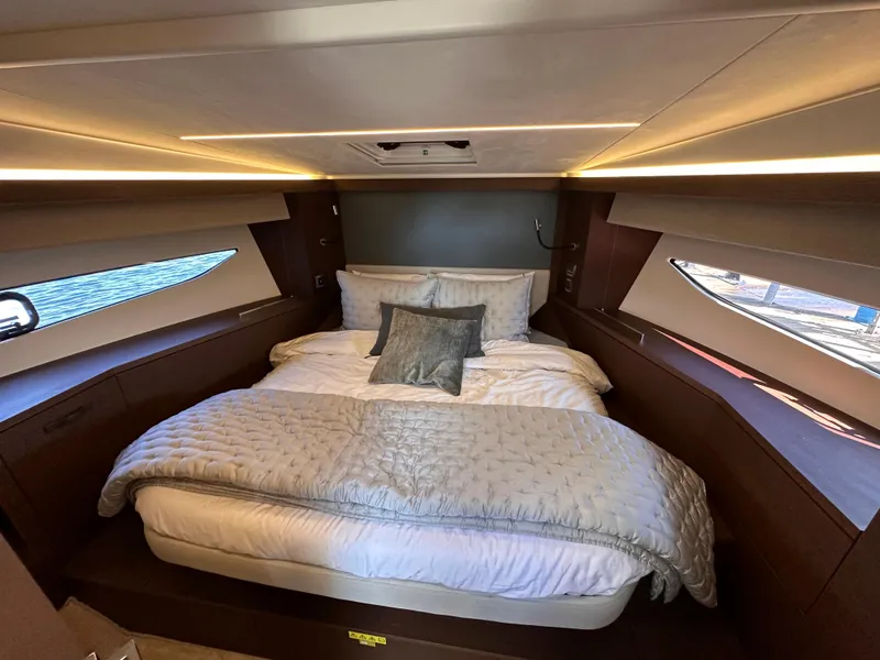 Slide: The Image of Luxurious bedroom interior of 2021 Prestige 420 S yacht with modern lighting and cozy bedding. - 36