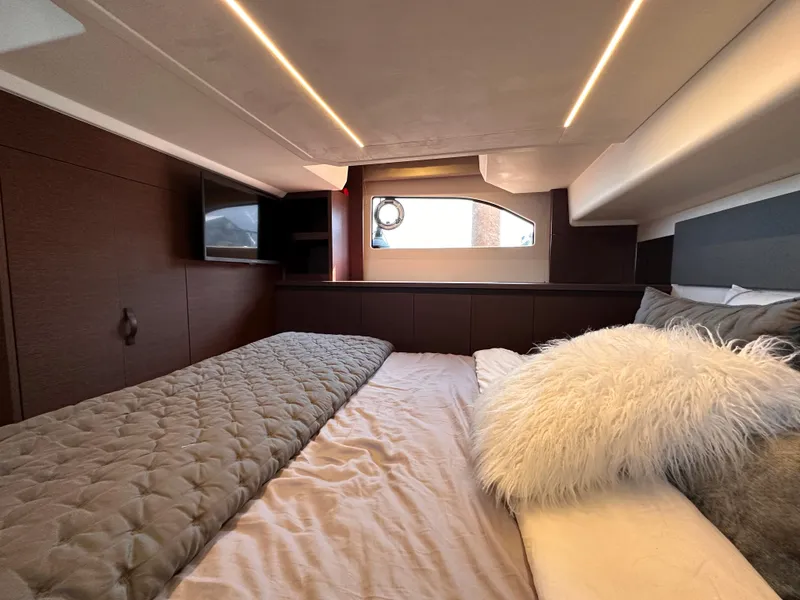 Slide: The Image of Luxurious bedroom interior of 2021 Prestige 420 S yacht with modern lighting and cozy bedding. - 43