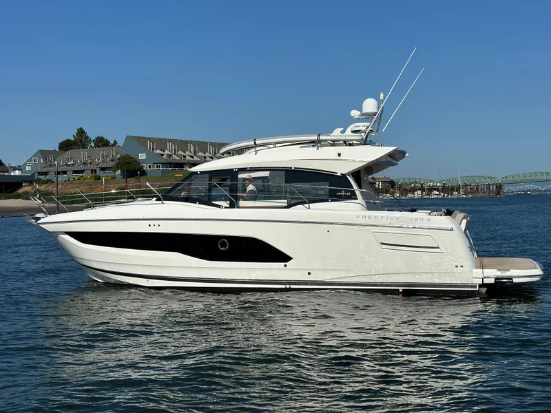 Slide: The Image of 2021 Prestige 420 S yacht on calm water with coastal background. - 5