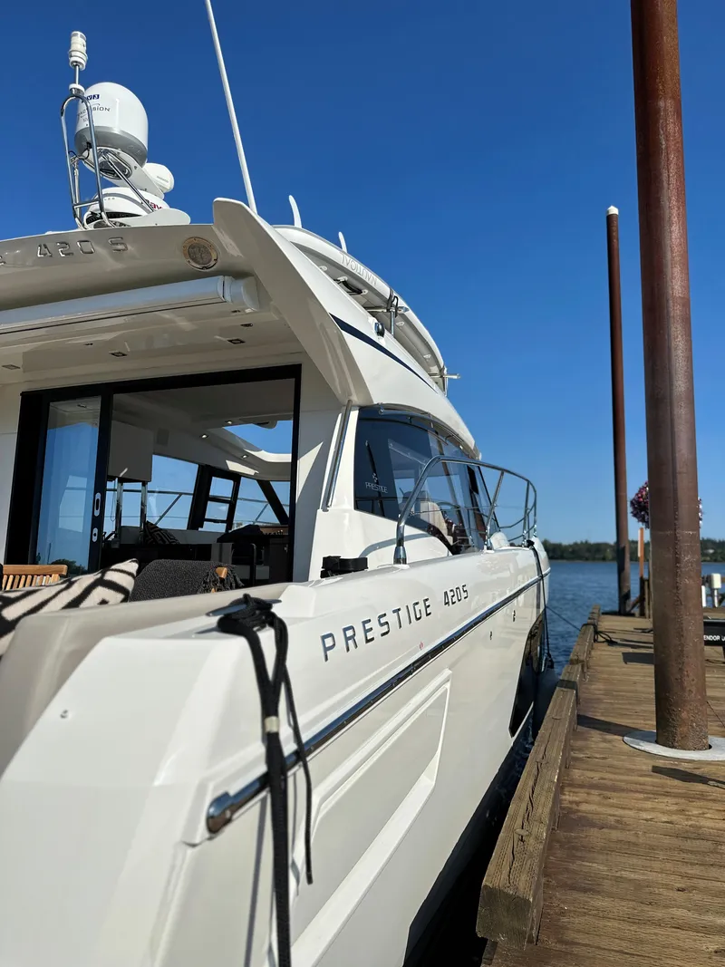 Slide: The Image of 2021 Prestige 420 S yacht docked at a marina on a sunny day. - 9