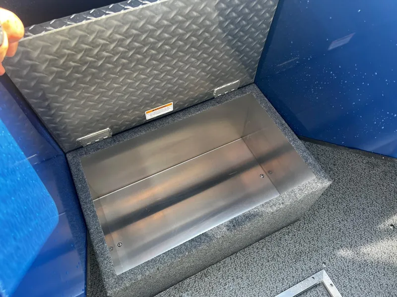 Slide: The Image of Storage compartment of 2024 Thunder Jet 22 Alexis OS boat with diamond plate lid. - 11