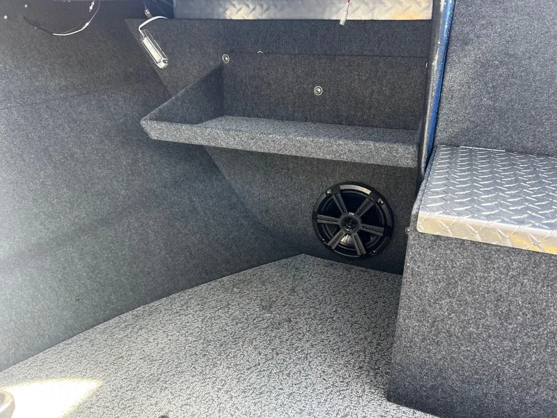 Slide: The Image of 2024 Thunder Jet 22 Alexis OS interior with speaker and storage shelf. - 12