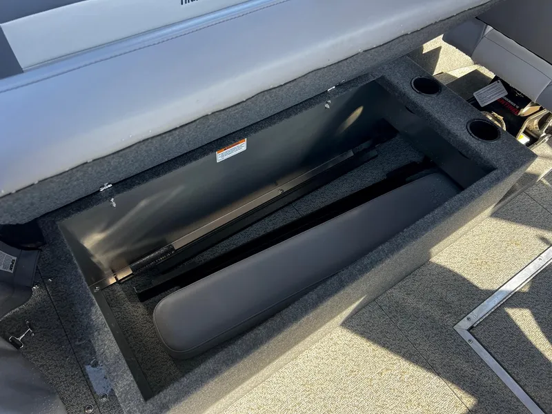Slide: The Image of 2024 Thunder Jet 22 Alexis OS boat storage compartment with padded interior. - 13