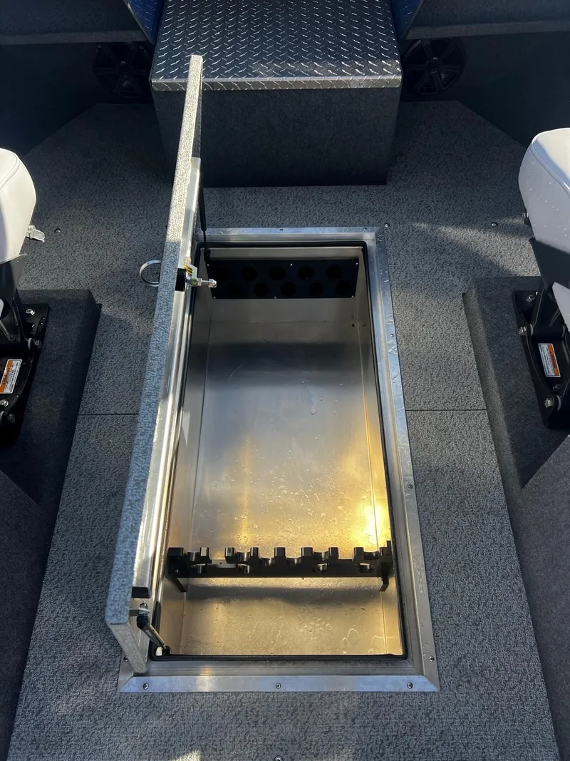 Slide: The Image of 2024 Thunder Jet 22 Alexis OS boat interior with open storage compartment. - 14