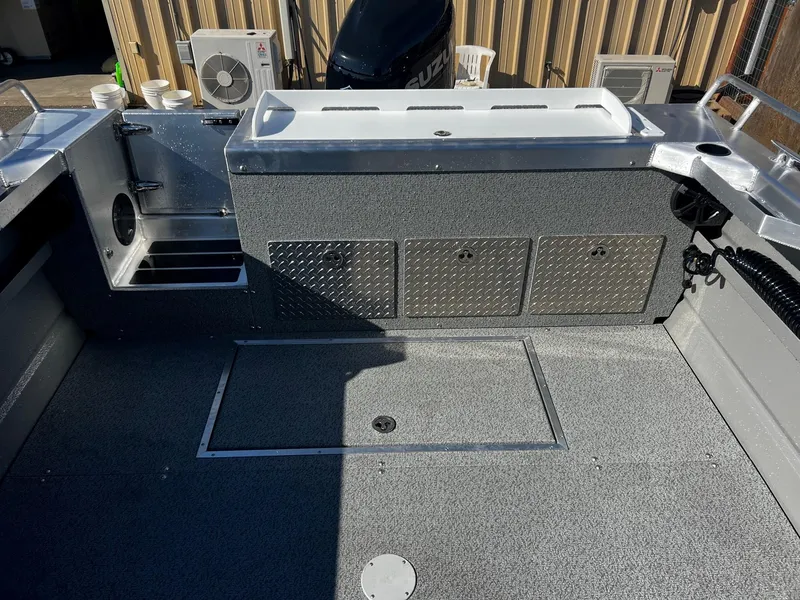 Slide: The Image of 2024 Thunder Jet 22 Alexis OS boat interior with storage compartments and fishing setup. - 15