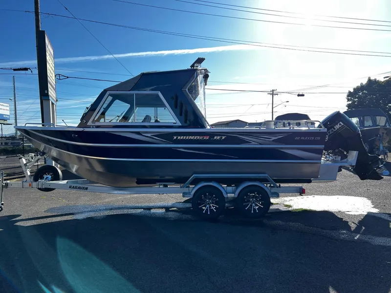 Slide: The Image of 2024 Thunder Jet 22 Alexis OS boat on a trailer in a parking lot. - 5