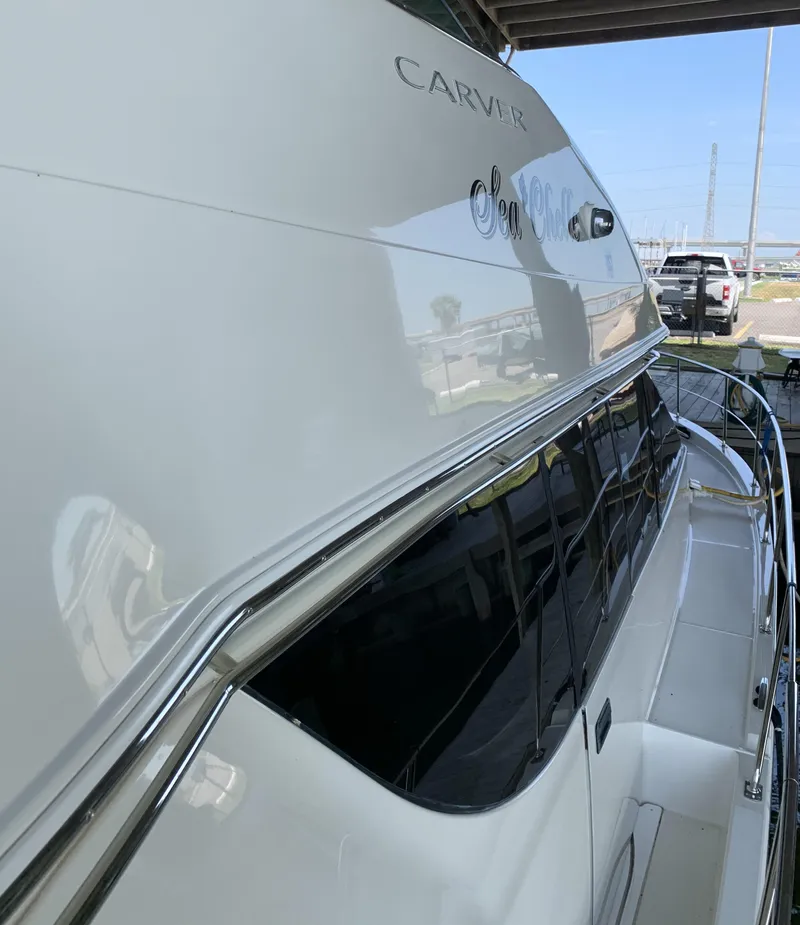 Slide: The Image of 2007 Carver 56 Voyager yacht, sleek design, docked under shelter. - 13