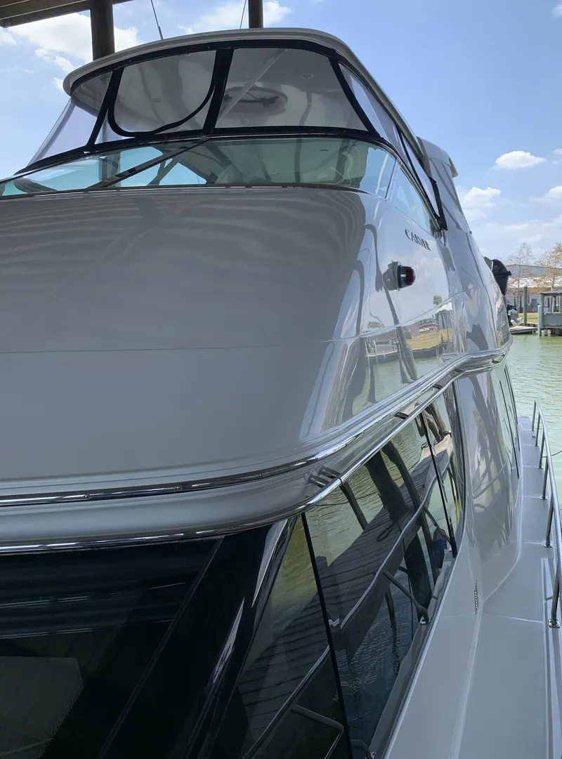 Slide: The Image of 2007 Carver 56 Voyager yacht docked, showcasing sleek design and modern features. - 18