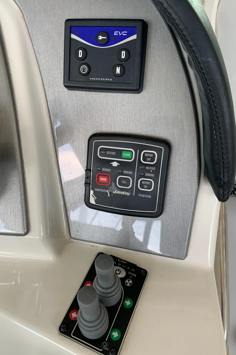 Slide: The Image of Control panel of a 2007 Carver 56 Voyager yacht with navigation and joystick controls. - 38