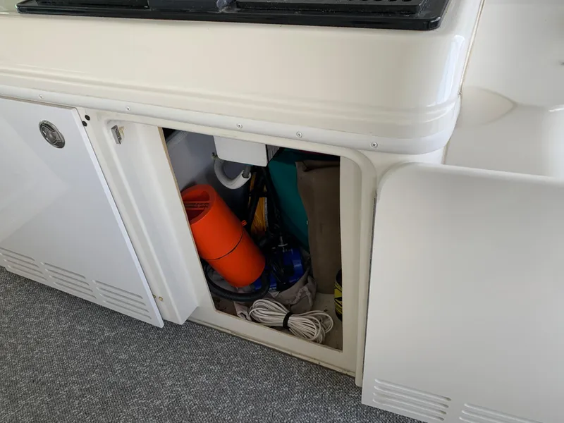 Slide: The Image of Storage compartment on a 2007 Carver 56 Voyager yacht, containing various boating equipment. - 48