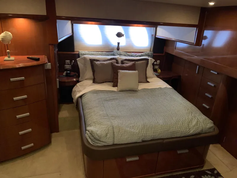 Slide: The Image of Luxurious bedroom interior of 2007 Carver 56 Voyager yacht with elegant wood cabinetry. - 2