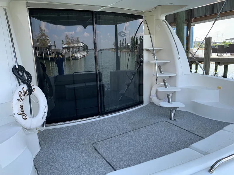 Slide: The Image of 2007 Carver 56 Voyager yacht deck with stairs, glass doors, and waterfront view. - 26