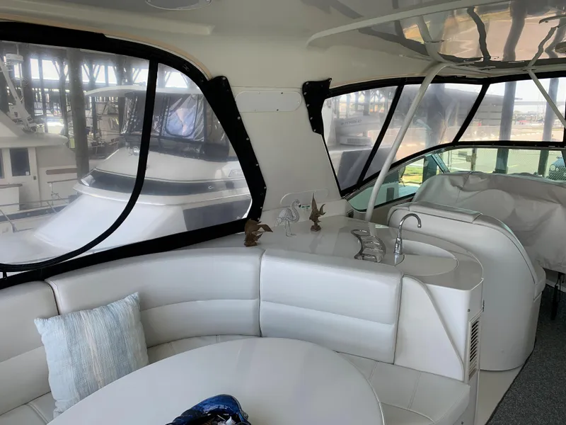 Slide: The Image of Luxurious interior of 2007 Carver 56 Voyager yacht with plush seating and panoramic windows. - 31