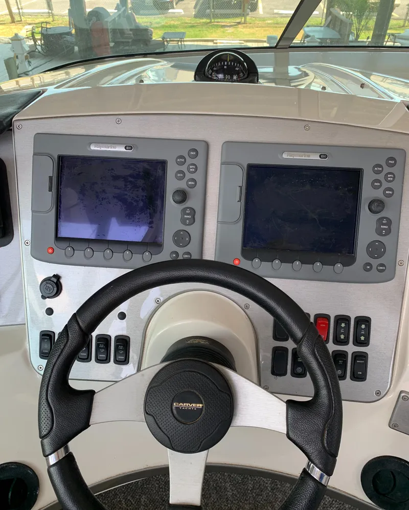 Slide: The Image of 2007 Carver 56 Voyager helm with dual navigation screens and steering wheel. - 36