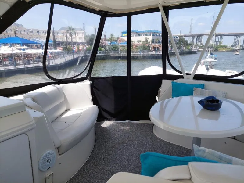 Slide: The Image of 2007 Carver 56 Voyager yacht interior with seating, table, and waterfront view. - 40