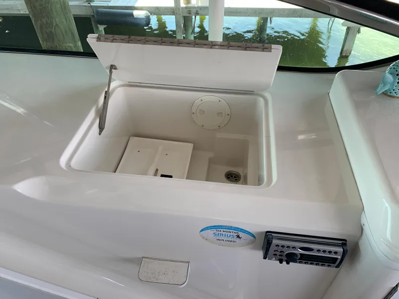 Slide: The Image of 2007 Carver 56 Voyager yacht sink with open lid, docked by water. - 42