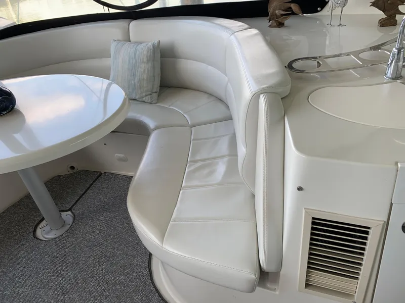 Slide: The Image of 2007 Carver 56 Voyager yacht interior with white leather seating and round table. - 44