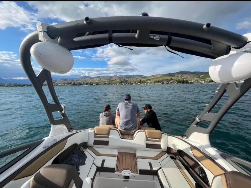 Slide: The Image of 2021 Yamaha Boats 212S on a lake with three people enjoying the view. - 6