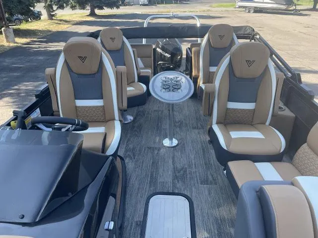 Slide: The Image of 2022 Viaggio D23Q boat interior with tan and white seating, steering console, and table. - 11