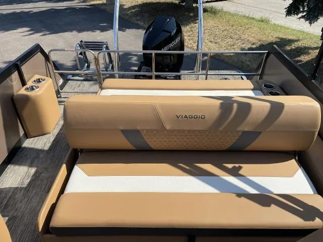 Slide: The Image of Viaggio D23S 2022 model boat with tan leather seating and Mercury outboard motor. - 10