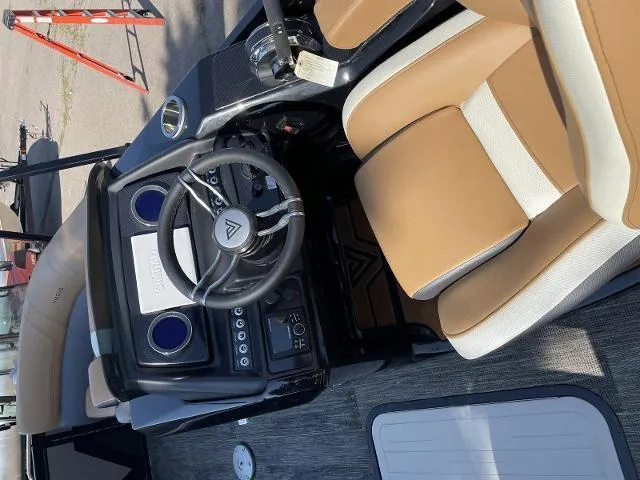 Slide: The Image of 2022 Viaggio D23S boat interior with tan and white seats, steering wheel, and control panel. - 11