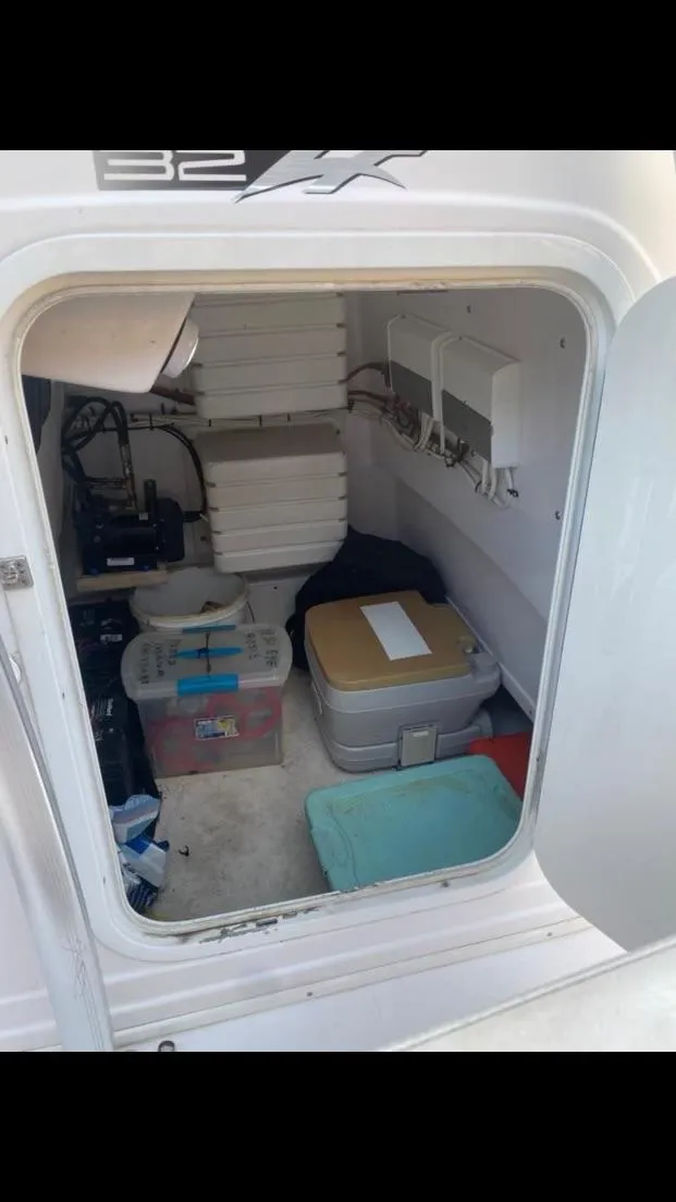 Slide: The Image of Storage compartment of a 2012 Donzi 32 ZF Open boat with various equipment. - 12