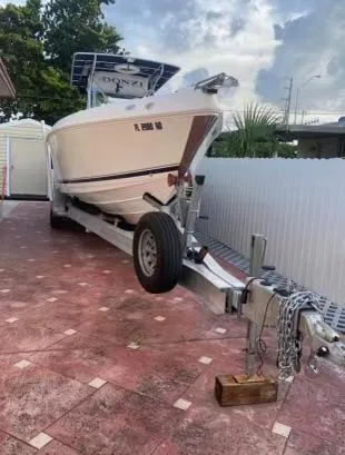 Slide: The Image of 2012 Donzi 32 ZF Open boat on a trailer in a driveway. - 4