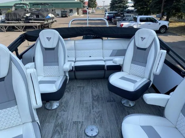 Slide: The Image of Viaggio D23Q 2022 boat interior with white and gray seating, docked at marina. - 7