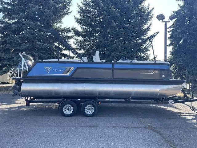 Slide: The Image of 2022 Viaggio D23U pontoon boat on a trailer, parked outdoors. - 0