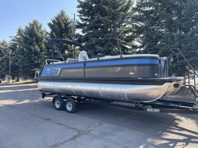 Slide: The Image of 2022 Viaggio D23U pontoon boat on trailer, parked outdoors. - 2