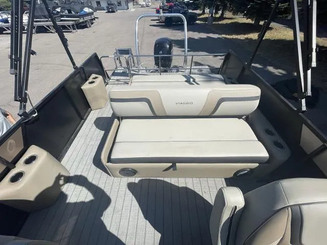 Slide: The Image of 2022 Viaggio L22S boat interior with beige seating and cup holders. - 11