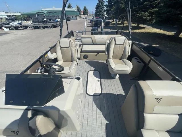 Slide: The Image of 2022 Viaggio L22S pontoon boat interior with beige seating and steering console. - 12