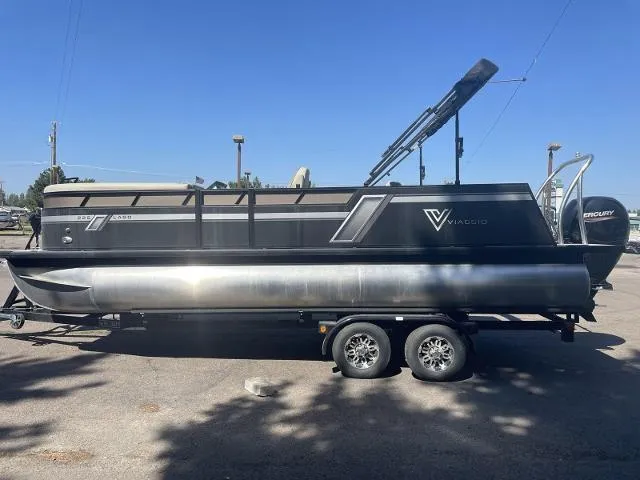 Slide: The Image of 2022 Viaggio L22S pontoon boat on a trailer in a parking lot. - 3