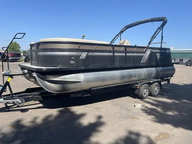 Slide: The Image of 2022 Viaggio L22S pontoon boat on a trailer in a parking lot. - 5