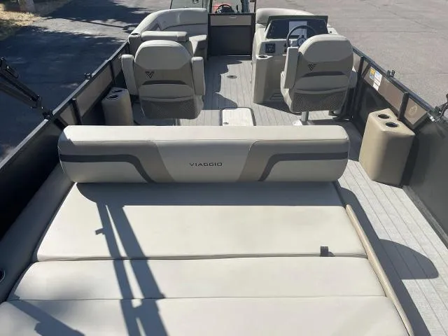 Slide: The Image of 2022 Viaggio L22S pontoon boat interior with beige seating and modern design. - 9