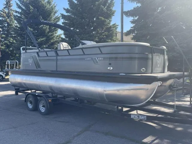 Slide: The Image of 2022 Viaggio L22U pontoon boat on a trailer in a parking lot. - 2