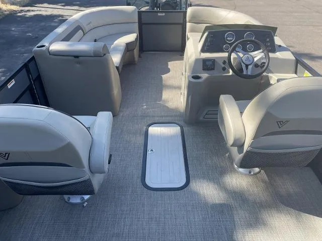 Slide: The Image of 2022 Viaggio L22U pontoon boat interior with beige seating and steering console. - 9