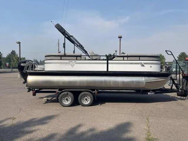 Slide: The Image of 2022 Viaggio DM20U pontoon boat on a trailer in a parking lot. - 0