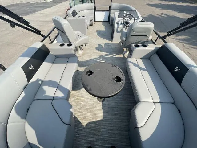 Slide: The Image of 2022 Viaggio DM20U pontoon boat interior with grey seating and round table. - 8