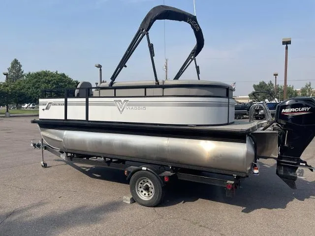 Slide: The Image of 2022 Viaggio DM16F pontoon boat on trailer with Mercury outboard motor. - 2