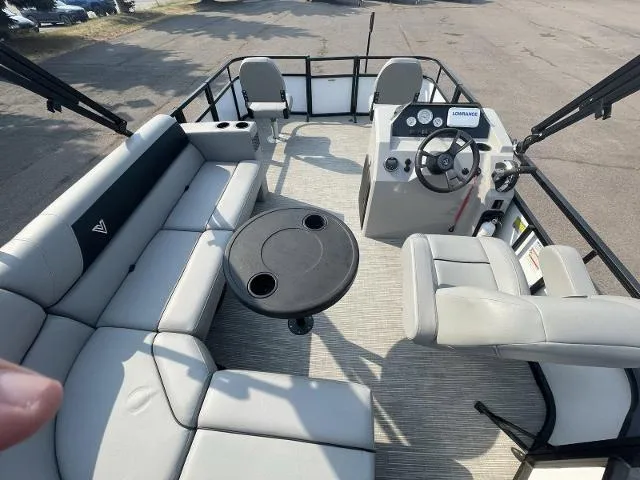 Slide: The Image of 2022 Viaggio DM16F pontoon boat interior with seating, table, and steering console. - 3