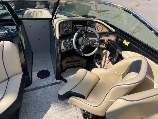 Slide: The Image of 2023 Sanger V237 SX boat interior with beige seats and modern dashboard. - 10