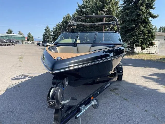 Slide: The Image of 2023 Sanger V237 SX boat on trailer in outdoor setting. - 2