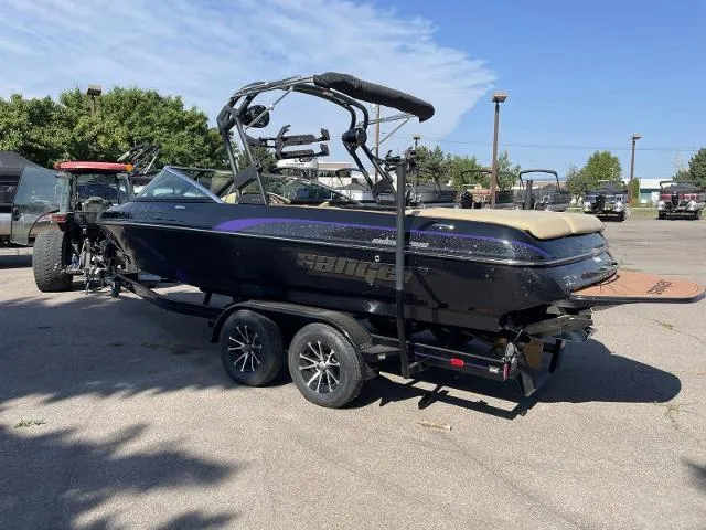 Slide: The Image of 2023 Sanger V237 SX boat on trailer in outdoor lot. - 3