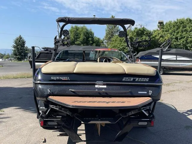 Slide: The Image of 2023 Sanger V237 SX boat, rear view, parked outdoors. - 4